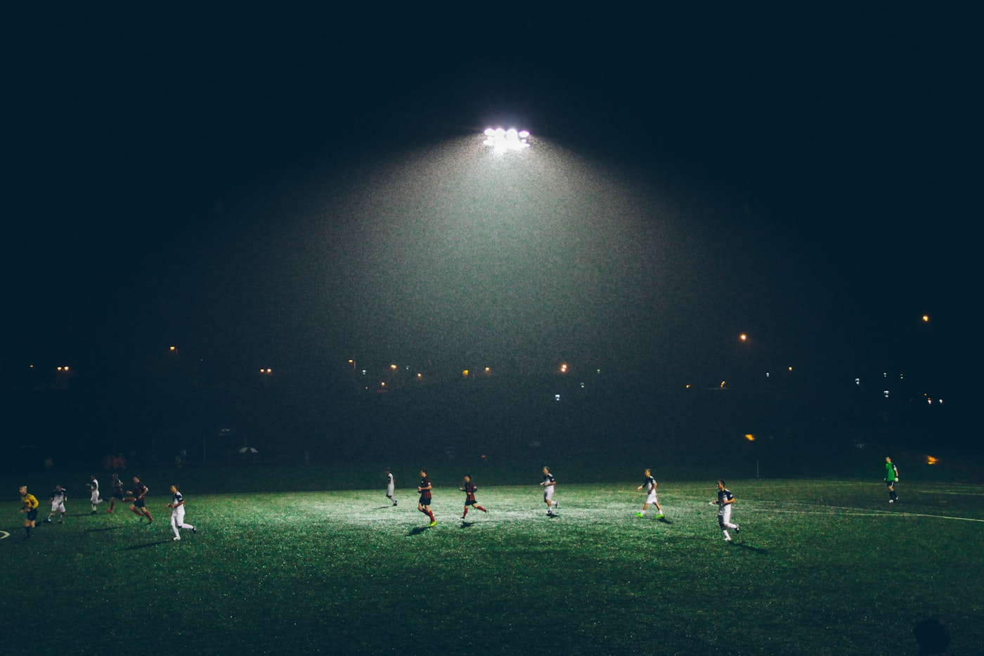 Wide view of a sports stadium under lights